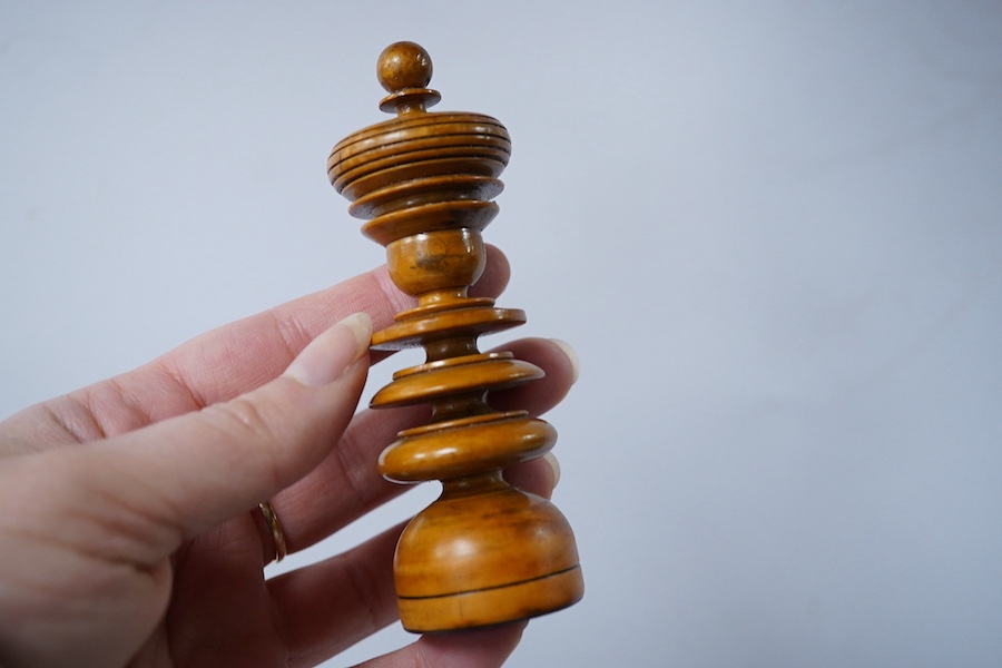 A turned wooden chess set in ebony and boxwood, king 10.5cm high, in a hardwood box. Condition - good.